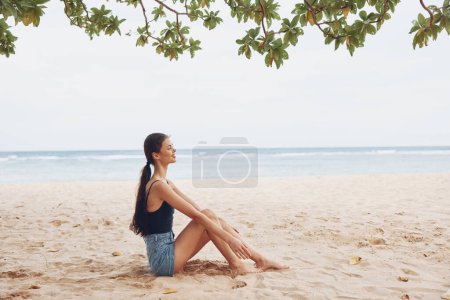 Photo for Woman attractive white long caucasian travel nature beach pretty summer lifestyle sea sitting young alone carefree back smile freedom view hair sand vacation - Royalty Free Image