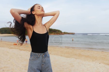 Photo for Sunset woman girl sea happiness lifestyle caucasian smiling ocean summer young smile female vacation nature beach coast carefree walking travel sand - Royalty Free Image