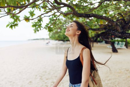 Photo for Woman summer sea carefree adult ocean sand vacation free young running shore walking beauty sunlight walk beach nature smile holiday outdoor - Royalty Free Image