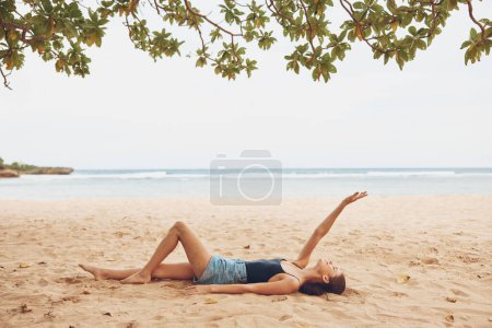 Photo for Woman freedom beauty sand outdoor bali coast tan body travel vacation sea beach sitting water summer ocean nature lifestyle smile person - Royalty Free Image