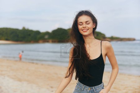 Photo for Tropical woman enjoyment sand walking carefree walk young copy-space holiday summer beach nature smile sunset lifestyle ocean sea vacation female person - Royalty Free Image