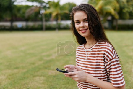 Photo for Woman smart call adult working spring girl lifestyle caucasian park browsing beautiful outdoor sitting palm happy blogger nature tree phone grass smiling - Royalty Free Image