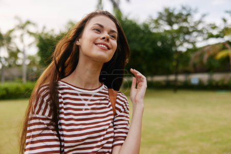 Photo for Black woman smiling lifestyle enjoy freedom park nature bag hipster outdoor health walk t-shirt carefree face fun care meditation beautiful joy summer - Royalty Free Image