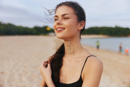Photo for Woman sunlight vacation ocean adult summer water smiling nature caucasian beach sunset sun sand girl relax peaceful walking lifestyle smile sea - Royalty Free Image