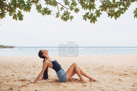Photo for Smile woman female beach sea view sitting hair natural long back nature young travel ocean water sand caucasian vacation girl freedom body outdoor - Royalty Free Image