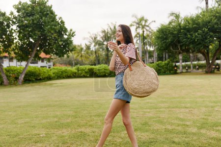 Photo for Smiling woman t-shirt beautiful nature bag freedom summer young relax meditation hipster meadow sun walk happiness park person lifestyle smile carefree - Royalty Free Image
