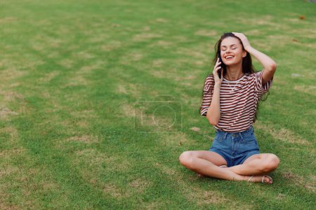 Photo for Woman human blogger grass seasonal happy app park green smiling smartphone lifestyle smile palm phone nature young cellphone using working tree girl - Royalty Free Image
