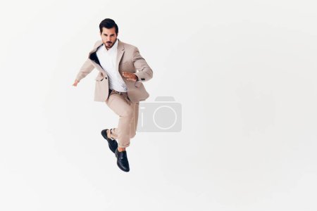 Photo for Man happy office studio suit up jumping smiling business cheerful young running beige shirt winner confident isolated victory professional model businessman - Royalty Free Image
