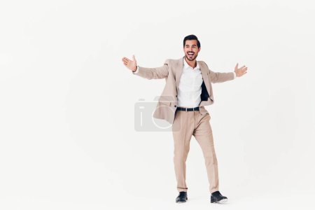 Photo for Man background suit businessman beige smiling success portrait stylish business sexy smile running happy flying studio victory attractive work winner standing - Royalty Free Image