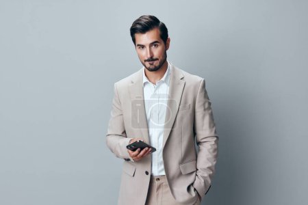 Photo for Man beard studio portrait male entrepreneur success smartphone suit call white business handsome gray smile phone happy corporate internet hold lifestyle - Royalty Free Image