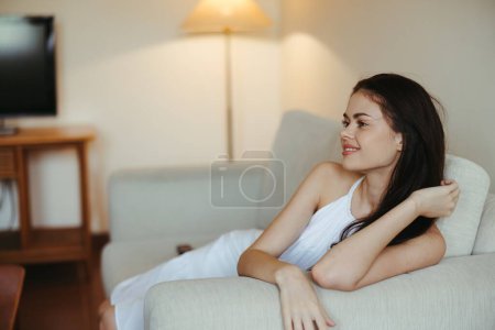 Photo for Happy girl smile lying on the couch at home, relaxing at home, comfort, sunshine. High quality photo - Royalty Free Image