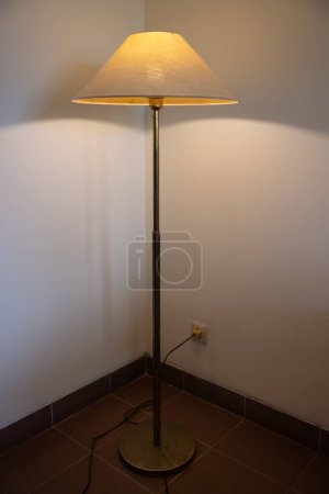 Photo for Interior with floor lamp and glow bulb in the dark at night, one lamp in the corner against a floor lamp wall. High quality photo - Royalty Free Image