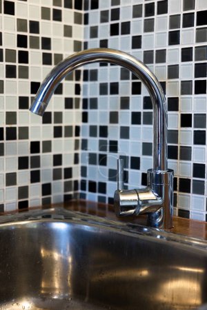 Photo for Clean sink with pouring water in the kitchen, metal faucet and sink in an old home interior. High quality photo - Royalty Free Image