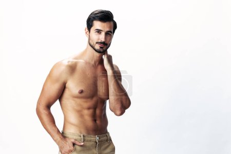 Photo for Male athlete model with naked torso and packs of abs sporty on white isolated background, trendy clothing style, copy space, space for text. High quality photo - Royalty Free Image