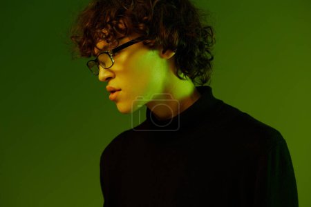 Photo for Young male portrait close-up in glasses fashion and style, hipster lifestyle, portrait green background mixed neon light, copy space. High quality photo - Royalty Free Image