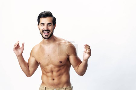 Photo for Male athlete model with naked torso and packs of abs sporty on white isolated background, trendy clothing style, copy space, space for text. High quality photo - Royalty Free Image