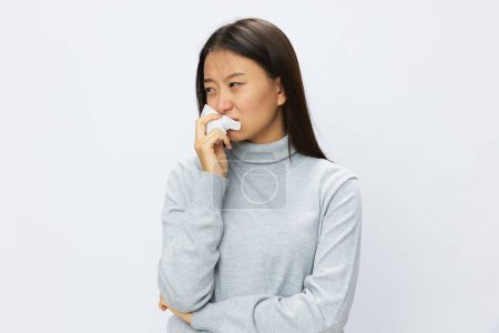 Téléchargez les photos : Femme asiatique tenant la main avec un mouchoir et toussant la grippe et le rhume, nez bouché maladie virale asthme et allergies covide, fond blanc. Photo de haute qualité - en image libre de droit