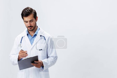 Photo for Man doctor in white coat with stethoscope and folder for notes and patient records smile and good test results on white isolated background, copy space, space for text, health. High quality photo - Royalty Free Image
