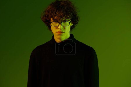 Photo for Man young man portrait close-up portrait in glasses fashion smile, hipster lifestyle, portrait green background mixed neon light, copy space. High quality photo - Royalty Free Image