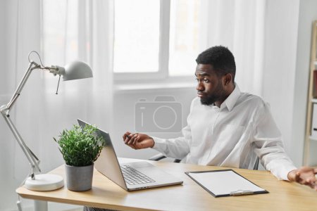 Photo for Office man conference home student blank indoor distance cyberspace education african american online career young desk african web space laptop computer freelancer job - Royalty Free Image