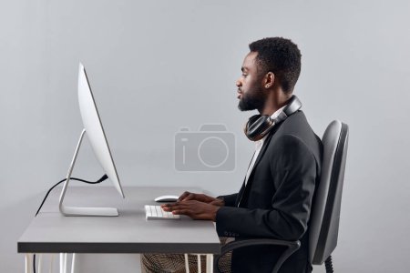 Photo for Man e-learning lesson african translate person zoom call space education study night work black headphones class video copy computer computer businessman wireless knowledge student laptop american - Royalty Free Image