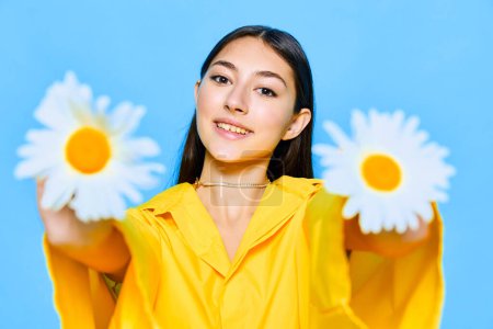 Photo for Woman flower model valentines blue yellow happiness young care lady positive emotion studio summer portrait cheerful brunette smile chamomile caucasian face day - Royalty Free Image