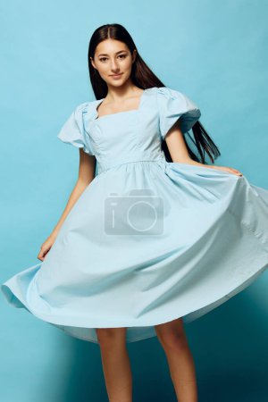 Photo for Space woman smile expression copy fashion portrait model female dance background blue young beautiful studio slim attractive style dress vogue summer girl - Royalty Free Image