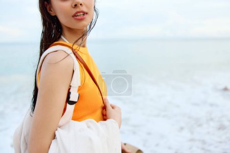 Foto de Mujer joven con una mochila pasea por la playa, vacaciones de verano en una isla junto al mar en Bali. Foto de alta calidad - Imagen libre de derechos