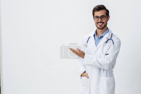 Photo for Man doctor in white coat and eyeglasses smile shows hand gestures signs on white isolated background looks into camera, copy space, space for text, health. High quality photo - Royalty Free Image