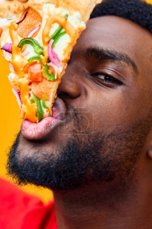 Photo for Man black pizza food guy food cheerful delivery online weight lifestyle happy obesity diet pizzeria adult background fast eater smile concept millennial enjoy - Royalty Free Image