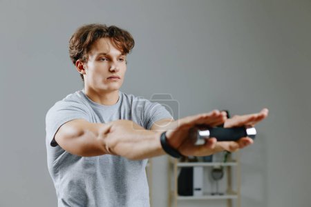 Photo for Sportswear man apartment laptop sport gray gym young dumbbells physical stretching hobby fitness activity home training muscle exercise health exercise indoor lifestyle - Royalty Free Image