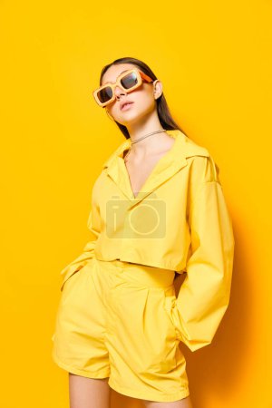 Photo for Outfit woman monochrome trendy style fashion studio romance happy sunglasses attractive lifestyle background creative lovely young pretty yellow girl beautiful person - Royalty Free Image