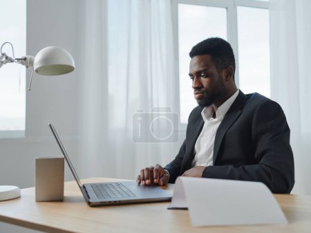 Photo for Man online office freelancer smiling american communication computer internet workplace web manager table space laptop career student blank person african education job businessman - Royalty Free Image