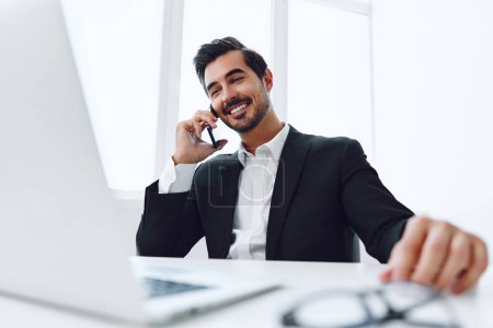 Photo for Working man white businessman sitting job phone conversation computer winner office talk communication happy professional laptop telephone lifestyle smile attractive smartphone - Royalty Free Image
