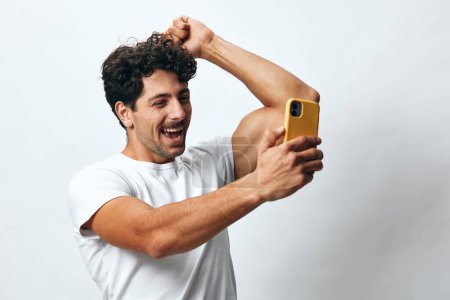 Photo for T-shirt man selfie expression connection online travel lifestyle message app attractive smartphone portrait phone masculine white caucasian technology hipster - Royalty Free Image