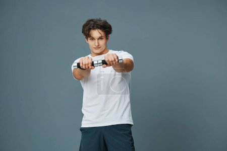 Photo for Exercise man weight caucasian young fit studio lifestyle bicep fitness body guy muscle training holding dumbbell heavy person torso background sport - Royalty Free Image