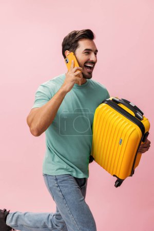 Photo for Tourist man hotel vacation mobile traveler travel passenger phone suitcase adult service smartphone baggage journey smile airport white studio guy - Royalty Free Image