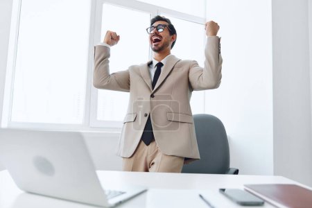 Photo for Technology man success winner successful office caucasian victory businessman lifestyle positive young happy white suit job computer excited business looking laptop professional - Royalty Free Image