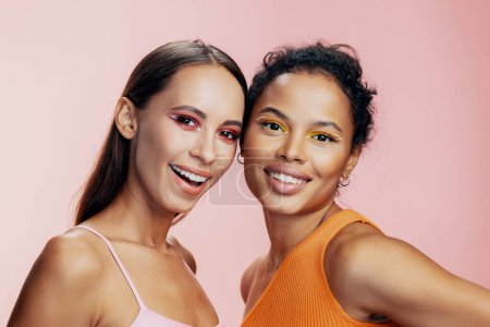 Photo for Woman african colorful beautiful bodycare studio two model healthy make-up girls race shine face eye together skin mixed american happy portrait pink beauty attractive - Royalty Free Image