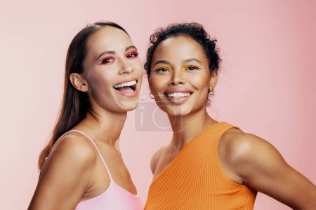 Photo for Race woman care colorful attractive together mixed skin happy pink healthy beauty american caucasian make-up african two portrait model girls face studio eye beautiful bodycare shine - Royalty Free Image