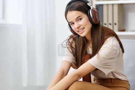 Photo for App space teenage mp3 copy listening happy technology chair home lifestyle music smart white young girl smile phone earphones meditation selfie - Royalty Free Image