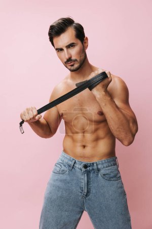 Photo for Man torso jeans naked sport pink fit model beauty body fashion boy belt muscular muscle background holiday shirtless strong bicep lifestyle bodybuilder sexy fitness posing - Royalty Free Image