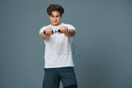 Photo for Man strong muscle exercise arm fitness gym care activity weight dumbbell caucasian sport bicep sportsman male young training holding fit lifestyle - Royalty Free Image