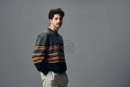 Photo for Man young confident fashion casual sweater face hand beautiful style copyspace natural smile attractive lifestyle hipster emotion trendy portrait stylish handsome - Royalty Free Image