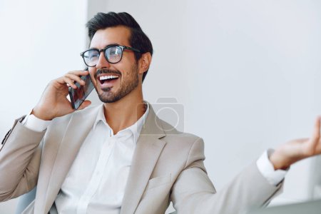Photo for Manager man winner office modern businessman successful workplace document young caucasian talk desk laptop smile lifestyle phone call professional smartphone computer - Royalty Free Image