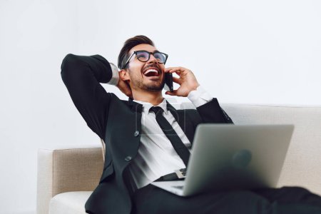 Photo for Computer man modern call conversation office successful winner smile phone occupation laptop internet job happy video talk glasses phone businessman people adult mobile - Royalty Free Image
