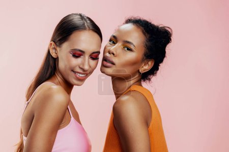 Photo for Woman model beautiful african skin make-up happy mixed bodycare girls beauty face attractive american shine race two portrait healthy pink studio colorful together - Royalty Free Image