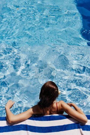 Photo for Woman resort water leisure bikini pool hotel swim relaxation holiday summer travel young blue happy female lifestyle beauty vacation - Royalty Free Image