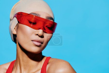 Photo for Positive woman red fashion asian person emotion pink blue smiling sunglasses swimwear expression happiness young trendy lady one adult beauty portrait white lifestyle black - Royalty Free Image