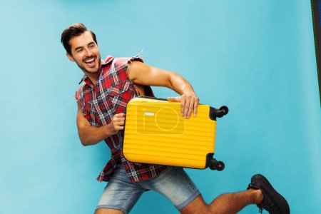 Photo for Man vacation trip happy traveler luggage yellow lifestyle blue tour copy background weekend guy ticket flight journey holiday space travel hipster suitcase studio baggage style - Royalty Free Image